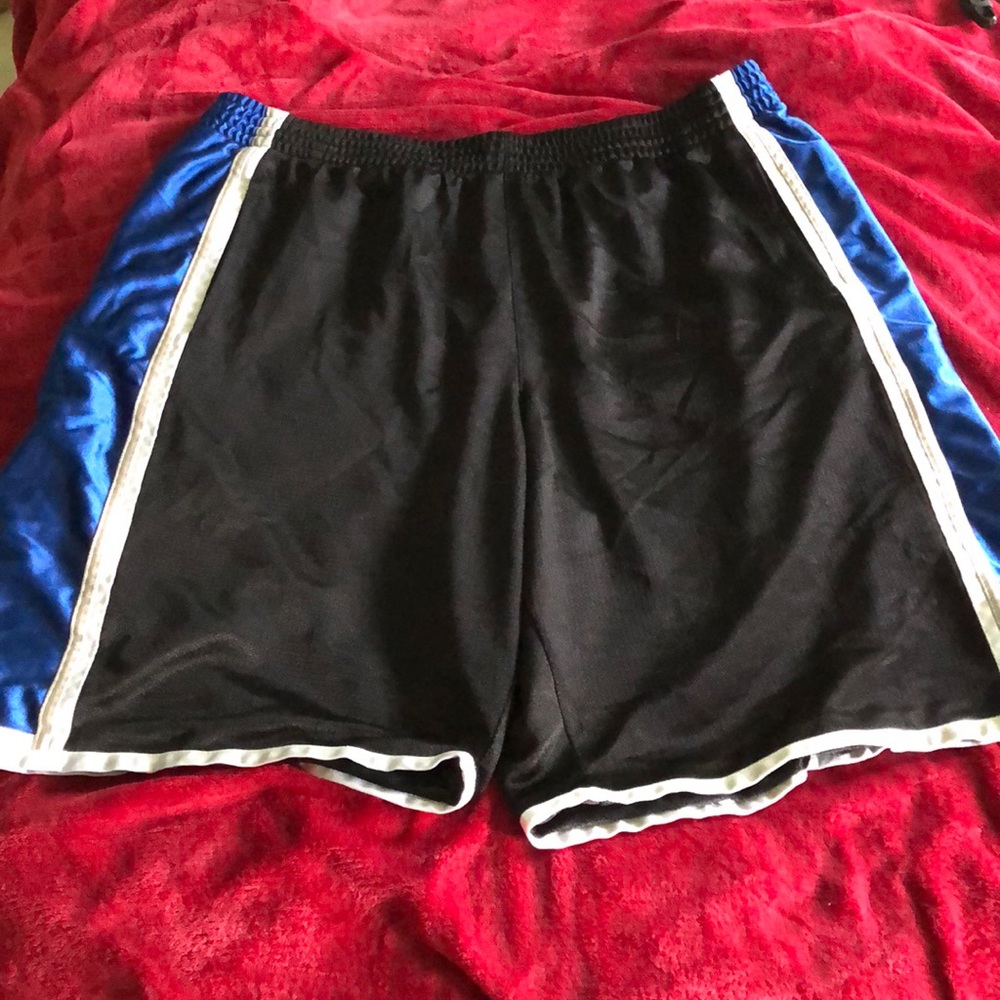 Black with blue side basketball shorts.